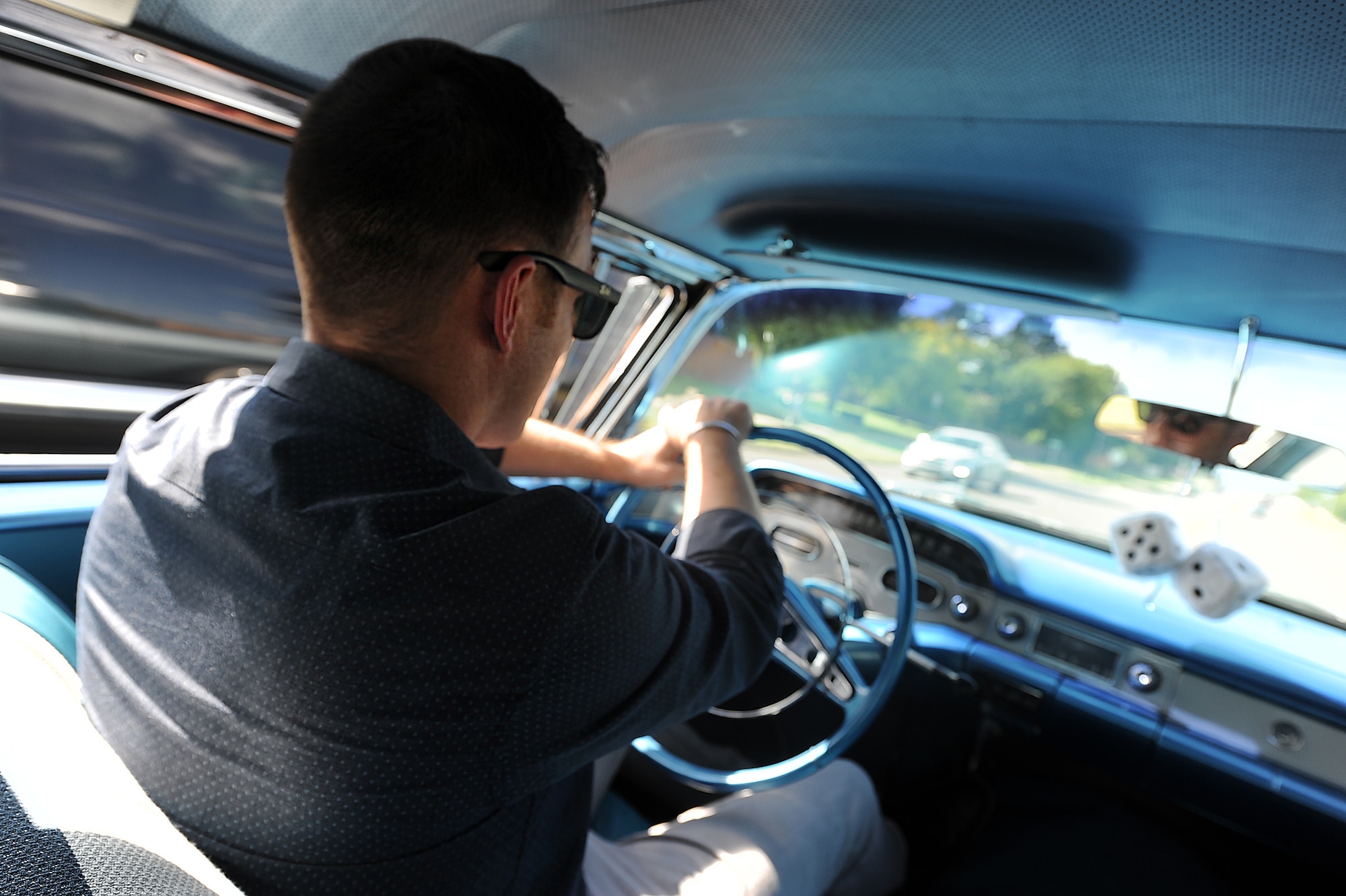 Master Sgt. Bobby McCrary, 22nd Force Support Squadron NCO in-charge of Honor Guard, drives his car 1958 Chevy Impala, July 13, 2017, at his home in Derby, Kan. Growing up McCrary traveled up and down the state of Texas with his grandfather looking for car parts and meeting other car enthusiasts. (U.S. Air Force photo/Senior Airman Jenna K. Caldwell)
