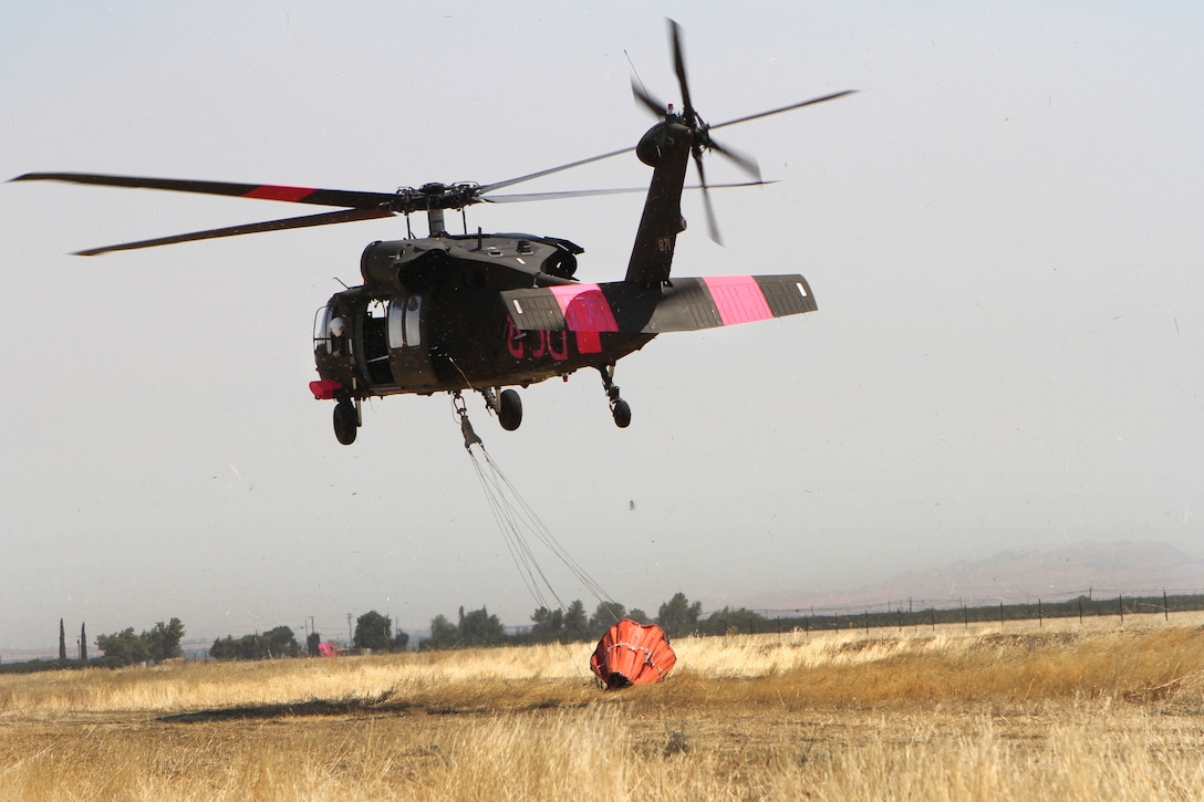 A UH-60 Black Hawk helicopter departs the Coalinga Municipal Airport, California, July 13, 2017, to continue supporting firefighting efforts during the Garza Fire in Kings County. Army National Guard photo by Staff Sgt. Eddie Siguenza