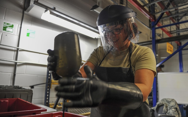 Senior Airman Jordan Parker, a materiel management journeyman with the 1st Special Operations Logistics Readiness Squadron, pours a cleaning solution into a gas mask drinking tube at Hurlburt Field, Fla., July 10, 2017. The chlorine solution is used to clean and sanitize gas masks before being reissued to deploying Air Commandos. (U.S. Air Force photo by Airman 1st Class Isaac O. Guest IV)