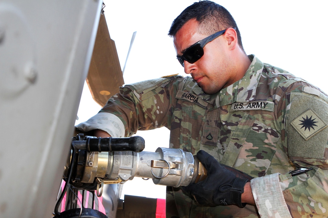 California Army National Guard Pfc. Vicente Garcia refuels a UH-60 Black Hawk helicopter at Coalinga Municipal Airport, California, July 13, 2017, before continuing supporting firefighting efforts during the Garza Fire in Kings County. Garcia is assigned to the California Army National Guard’s Company E, 1st Battalion, 140th Aviation Regiment. Army National Guard photo by Staff Sgt. Eddie Siguenza