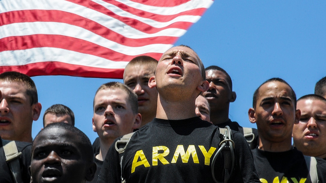 Soldiers sing “The Army Goes Rolling Along,” the Army’s official song, at Williams Stadium at Fort Lee, Va., July 14, 2017, during an event to celebrate the installation’s centennial. Army photo by Terrance Bell