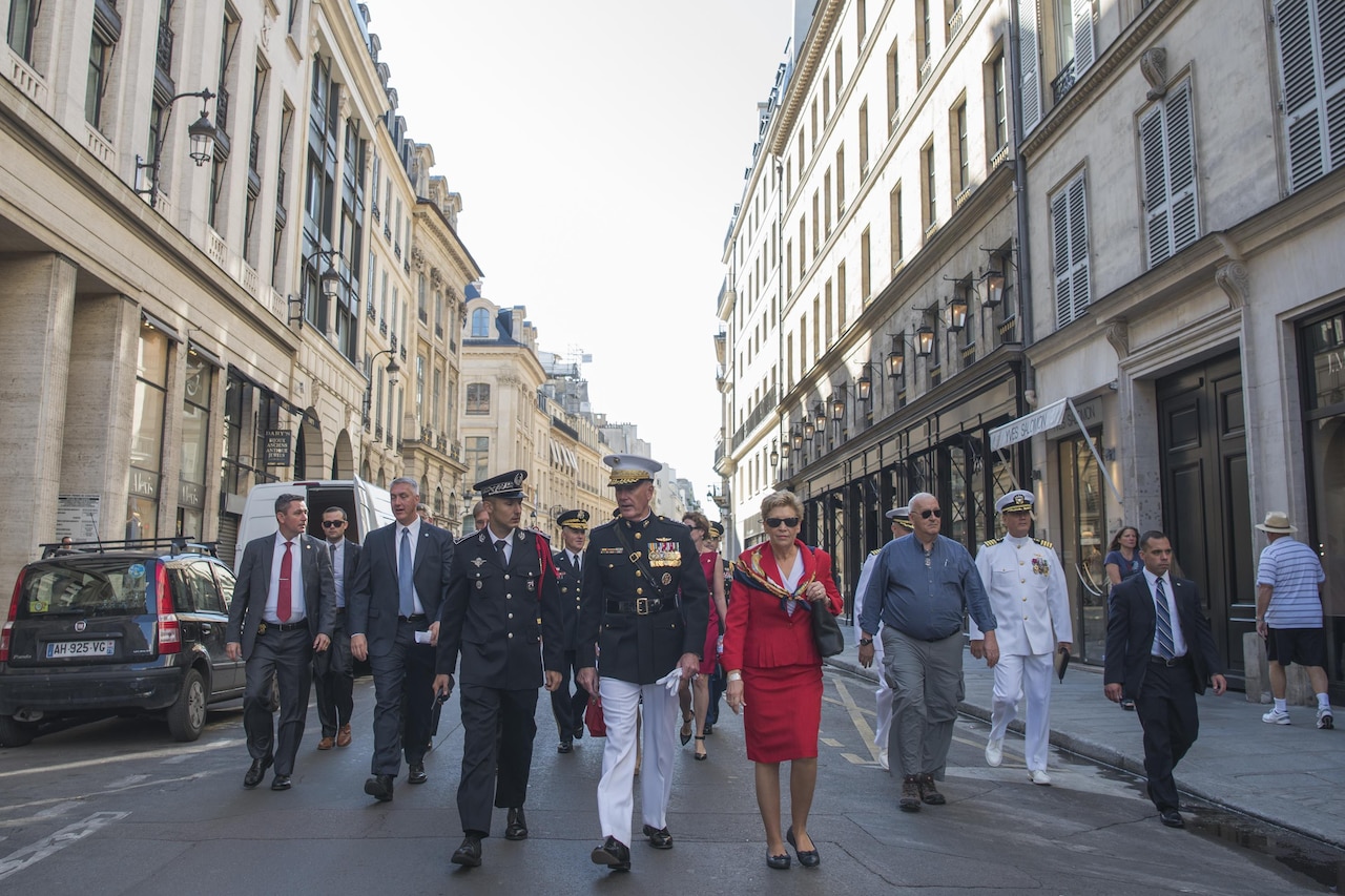 Marine Corps Gen. Joe Dunford, the chairman of the Joint Chiefs of Staff, and his wife, Ellyn, walk through the streets of Paris to attend the annual Bastille Day military parade in Paris, July 14, 2017. American troops led the parade to mark the centennial of American troops arriving in France during World War I. DoD photo by Navy Petty Officer 2nd Class Dominique Pineiro