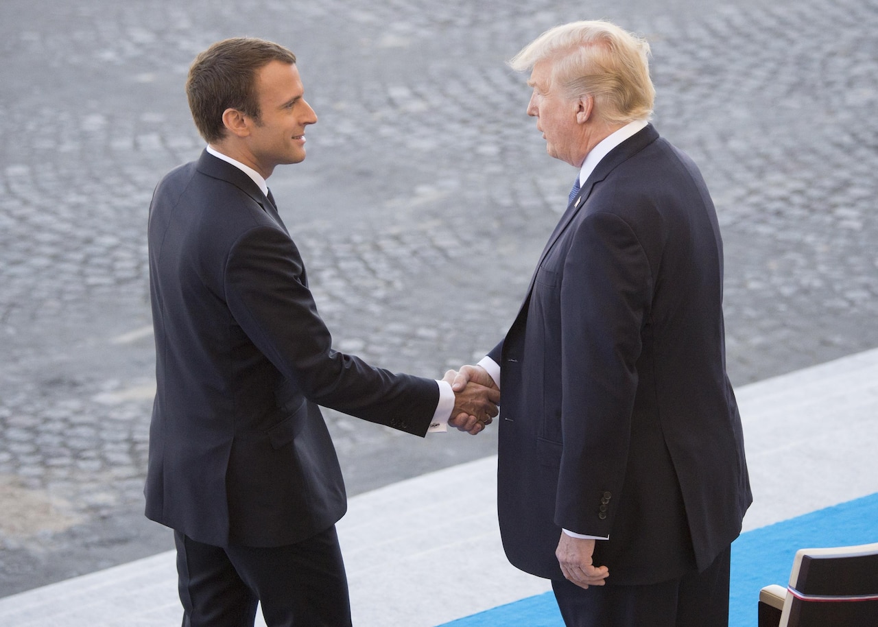 French President Emmanuel Macron welcomes President Donald J. Trump to the reviewing stand for the Bastille Day military parade in Paris, July 14, 2017. Macron and Trump recognized the continuing strength of the U.S.-France alliance from World War I to today. DoD photo by Navy Petty Officer 2nd Class Dominique Pineiro