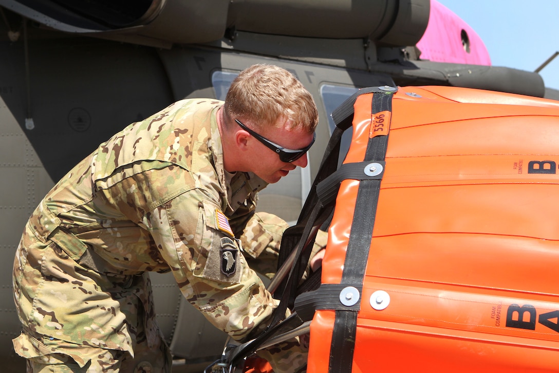 California Army National Guard Sgt. Bob Batham prepares a 2,600-gallon bucket firefighting system at Coalinga Municipal Airport, California, July 13, 2017, before assisting efforts during the Garza Fire in Kings County. Batham is assigned to the California Army National Guard’s 1st Battalion, 140th Aviation Regiment. Army National Guard photo by Staff Sgt. Eddie Siguenza 