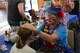 Donna Trout, also known as Rainbow Trout the clown, paints children’s faces at Offutt’s base lake on July 8, 2017 during the annual fireworks display. Several family activities took place at the celebration including face painting, treasure hunt and a performance from the Heartland of America Band. (U.S. Air Force photo by Zachary Hada)