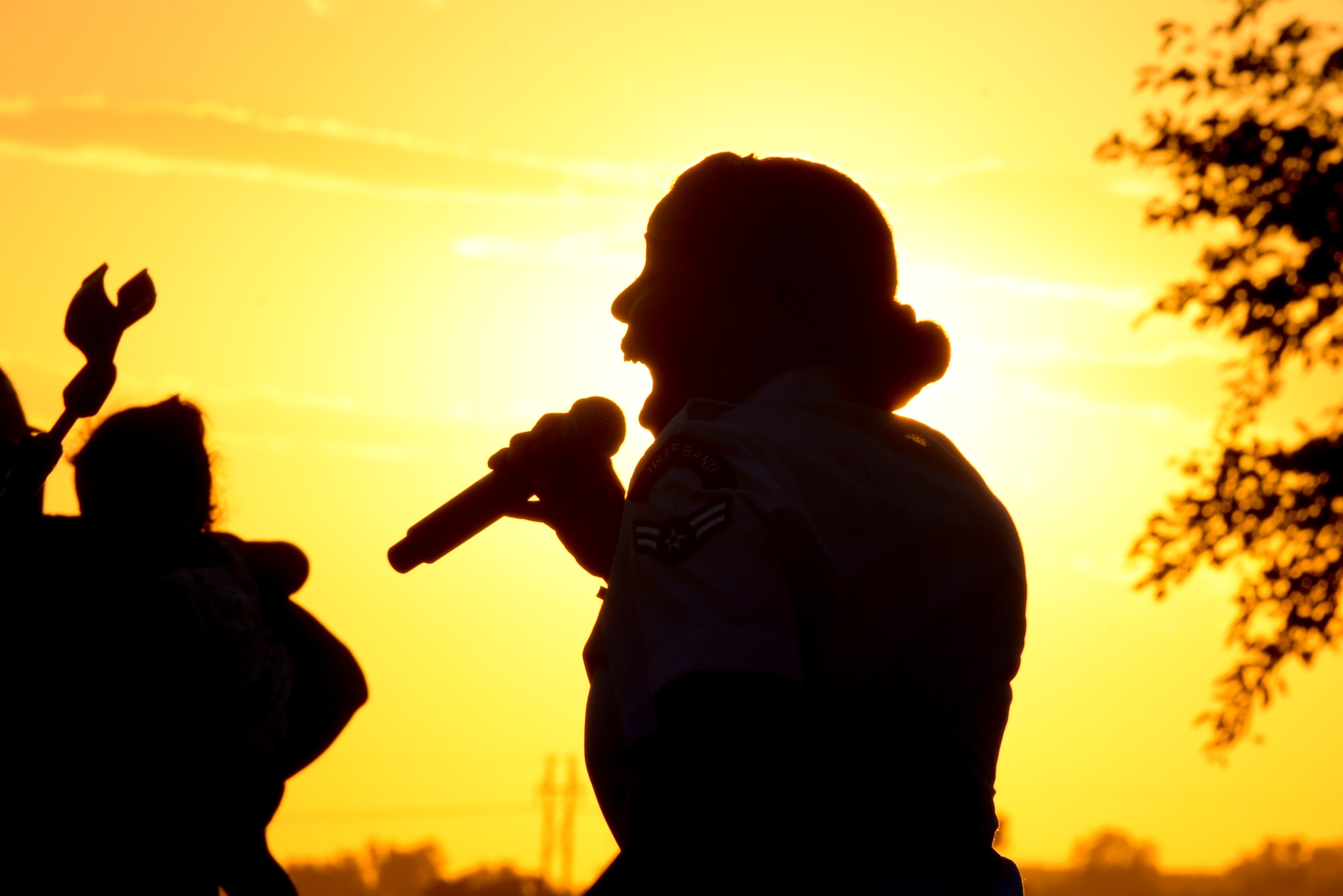 Airman 1st Class Sierra Bailey, a vocalist with the U.S. Heartland of America Band, sings at Offutt’s base lake on July 8, 2017 during the annual fireworks display. The Heartland of America Band is a group of Air Force professional musicians whose backgrounds include advanced degrees in music performance and whose broad mastery of musical styles range from classic to contemporary, jazz to country and pop to rock. (U.S. Air Force photo by Zachary Hada)