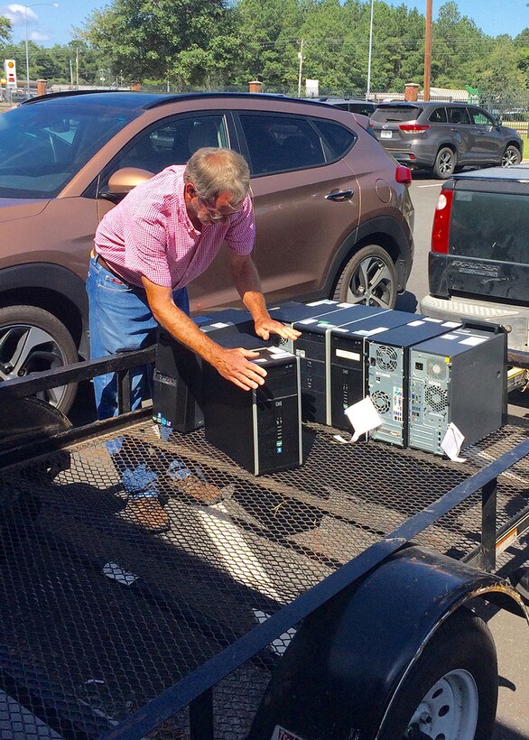 Tommy Gentry loads one-time military computers on to a trailer that his school district acquired through DLA Disposition Services' Computers for Learning program