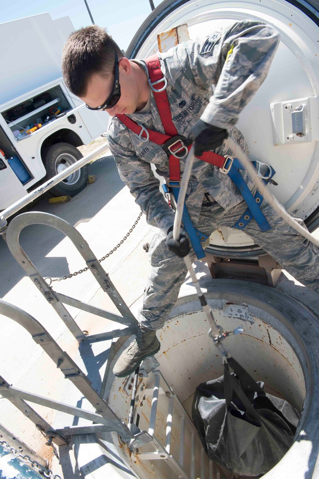 Senior Airman Logan Hershberger, 90th Missile Maintenance Squadron electromechanical team chief, lowers equipment into a launch facility during code change in the 90th Missile Wing missile complex, June 20, 2017. Multiple wings contribute to the code change effort. Mighty Ninety maintainers perform the code change, security forces squadrons secure the sites and the 90th Force Support Squadron provides additional care to the personnel in the field. Code change ensures the safety, security and effectiveness of America’s ICBM arsenal, which is the bedrock of nuclear deterrence. (U.S. Air Force photo by Staff Sgt. Christopher Ruano)