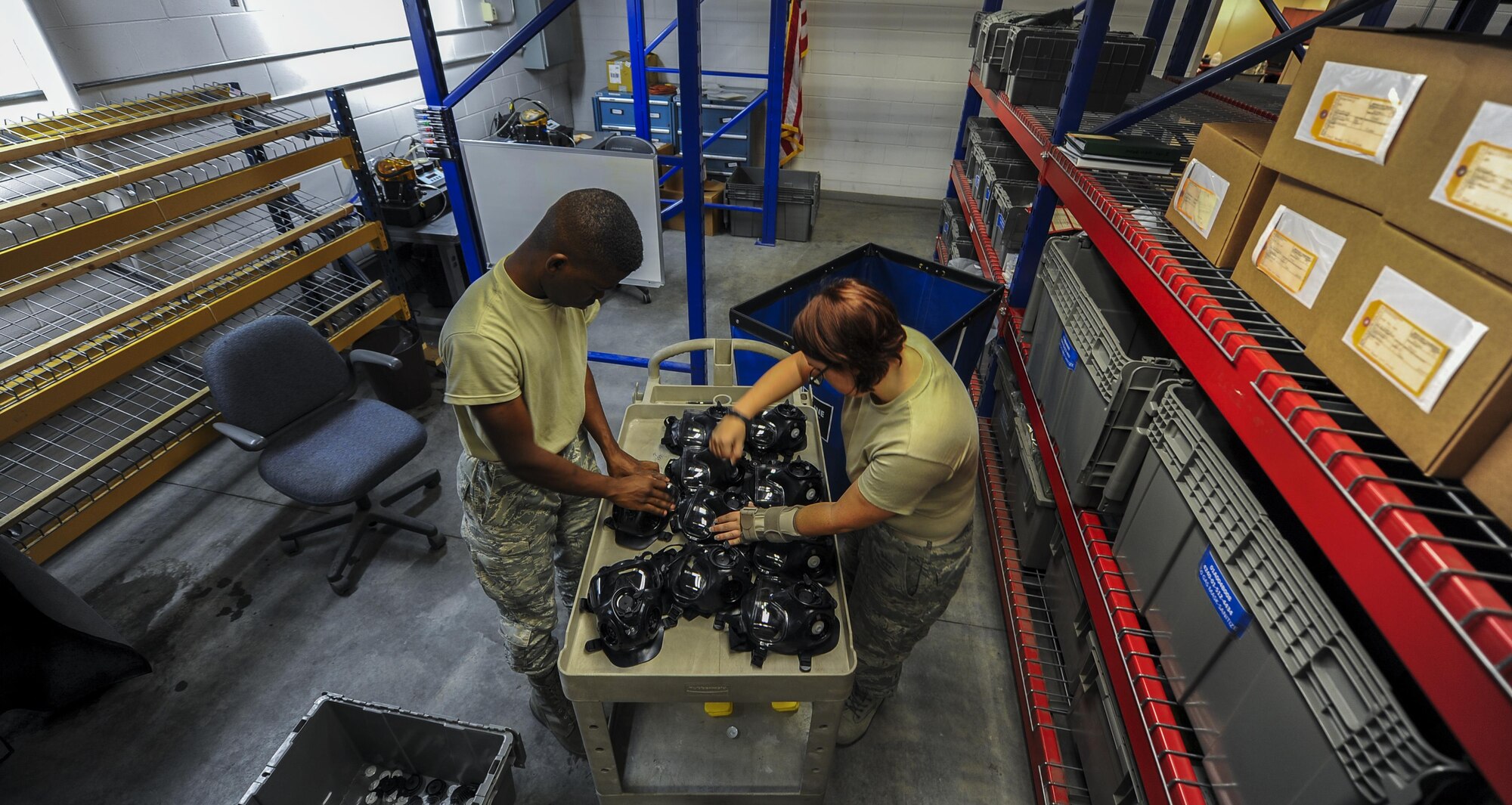 Airman 1st Class Terrence Grandberry, left, and Senior Airman Jordan Parker, materiel management journeymen with the 1st Special Operations Logistics Readiness Squadron, prepare gas masks for cleaning at Hurlburt Field, Fla., July 10, 2017. All external parts are removed from the gas masks prior to cleaning to make sure each internal component is properly cleaned. (U.S. Air Force photo by Airman 1st Class Isaac O. Guest IV)