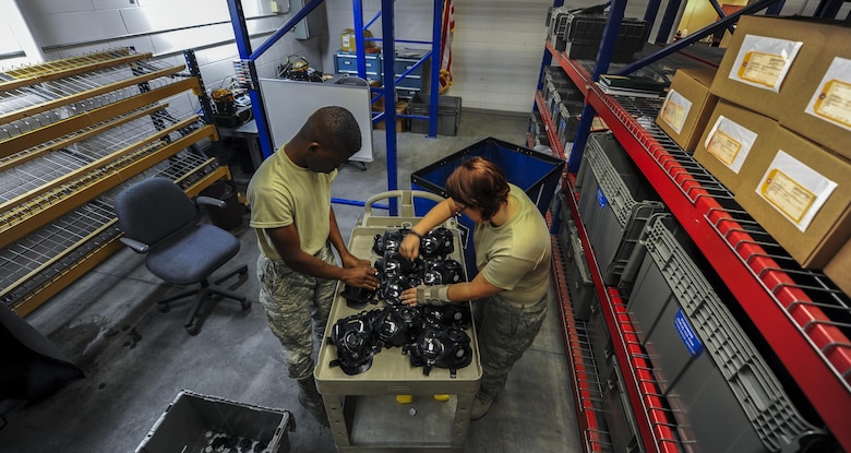 Airman 1st Class Terrence Grandberry, left, and Senior Airman Jordan Parker, materiel management journeymen with the 1st Special Operations Logistics Readiness Squadron, prepare gas masks for cleaning at Hurlburt Field, Fla., July 10, 2017. All external parts are removed from the gas masks prior to cleaning to make sure each internal component is properly cleaned. (U.S. Air Force photo by Airman 1st Class Isaac O. Guest IV)