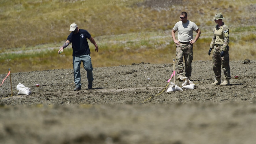 An FBI Special Agent Bomb Technician instructs 28th Civil Engineer Squadron Explosive Ordinance Disposal Airmen while preparing explosives during a National Improvised Explosive Familiarization course at Ellsworth Air Force Base, S.D., July 12, 2017. The joint training exercise provides an opportunity for several agencies to work together, strengthening their interoperability and readiness in case of a real-world emergency. (U.S. Air Force photo by Airman 1st Class Randahl J. Jenson)