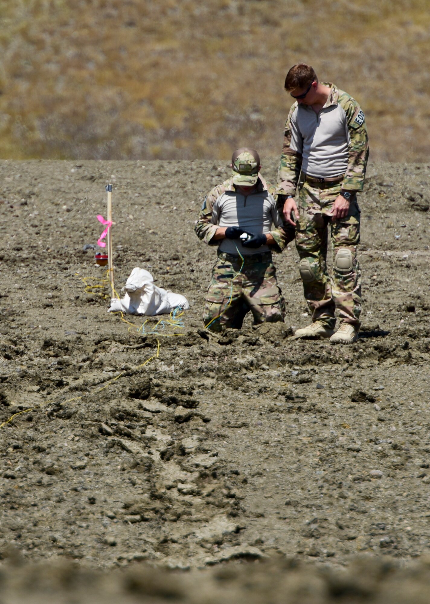 28th Civil Engineer Squadron Explosive Ordinance Disposal Airmen prepare an explosive for detonation during a National Improvised Explosive Familiarization course at Ellsworth Air Force Base, S.D., July 12, 2017. The course provided an opportunity for EOD Airmen to share their expertise while learning from outside agencies. (U.S. Air Force photo by Airman 1st Class Randahl J. Jenson)