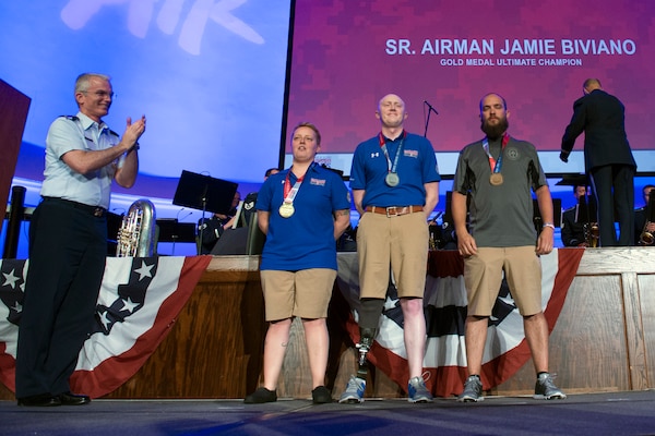 Vice Chairman of the Joint Chiefs of Staff Gen. Paul J. Selva applauds Ultimate Champion Medal recipients from left Senior Airman Jamie Biviano, gold, Capt. Austin Williamson, silver, and Staff. Sgt. John Stanz, bronze, during the 2017 Department of Defense Warrior Games in Chicago July 8, 2017. 
