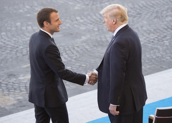 French President Emmanuel Macron welcomes President Donald J. Trump to the reviewing stand for the Bastille Day military parade in Paris, July 14, 2017. Macron and Trump recognized the continuing strength of the U.S.-France alliance from World War I to today.