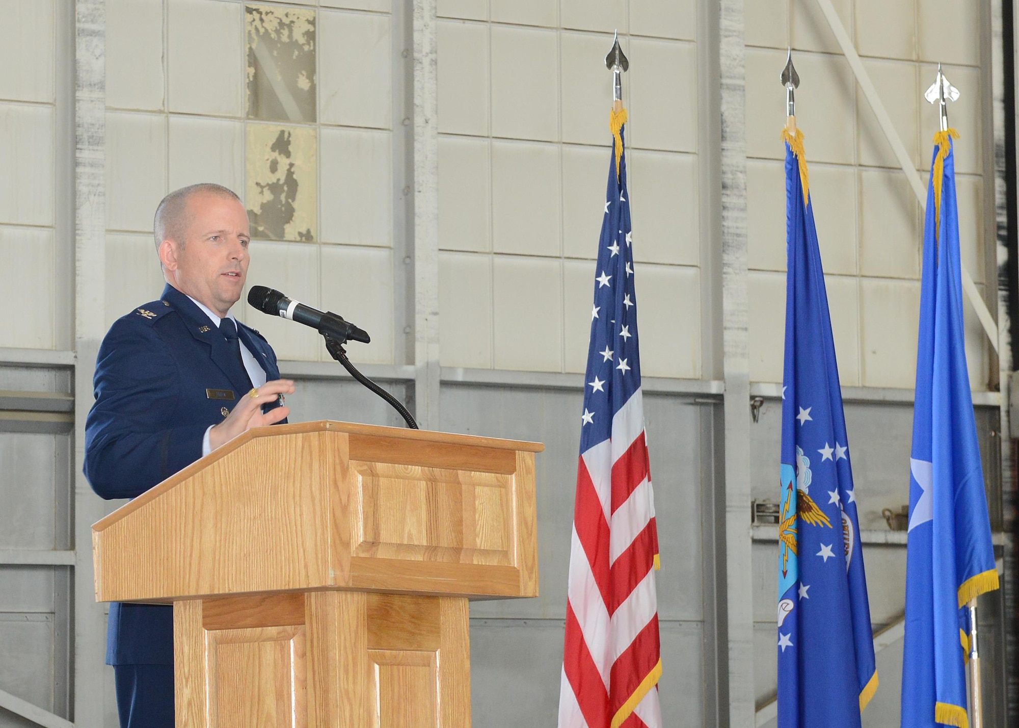 Col. Matthew Higer, U.S. Air Force Test Pilot School commandant, addresses the audience after taking the reins of the school in a change of command ceremony July 14 in Hangar 1207. (U.S. Air Force photo by Kenji Thuloweit)