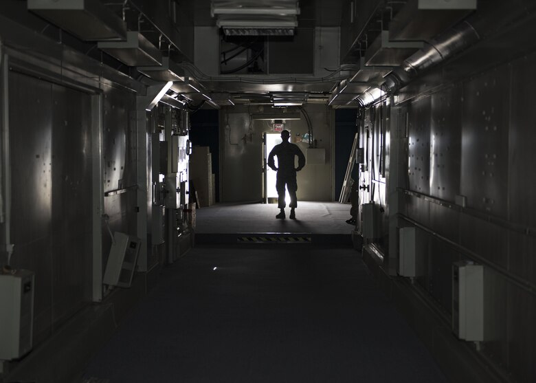 Tech. Sgt. Benjamin Whitfield, 92nd Air Refueling Wing historic property custodian, stands in the cavernous hull of "Little John", a former KC-135 simulator July 10, 2017, at Fairchild Air Force Base, Washington. The KC-135 and B-52 were often used together on missions, so training often occurred in the same place. (U.S. Air Force photo / Airman 1st Class Ryan Lackey)