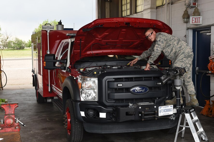 Airman 1st Class Alex Johnson, 90th Logistics Readiness Squadron mission generation and vehicle equipment maintenance apprentice, checks fluid levels in a fire emergency response vehicle, at F.E. Warren Air Force Base, Wyo., July 6, 2017. Maintaining proper fluid level is very important for the upkeep and maintenance of vehicles. (U.S. Air Force photo by Terry Higgins) 