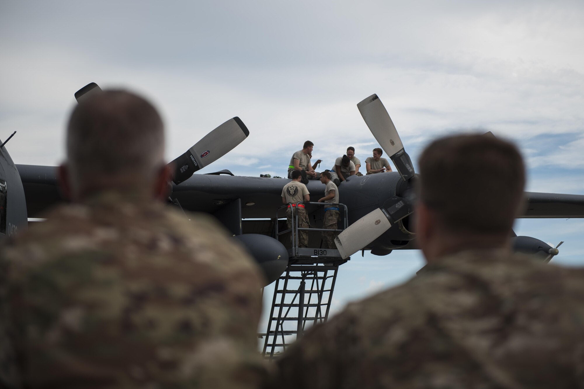 Maj. Jeff Westerman, commander of the 901st Special Operations Maintenance Squadron, and Senior Master Sgt. Carl Snider, superintendent of the 901st SOAMXS, observe their personnel as they repair an MC-130H Combat Talon II engine malfunction at Hurlburt Field, Fla., July 7, 2017. Commanders and superintendents frequently visit their Airmen on the flight line to enhance readiness and boost morale as they get after the mission in the heat, cold or rain. (U.S. Air Force photo by Tech. Sgt. Jeffrey Curtin)