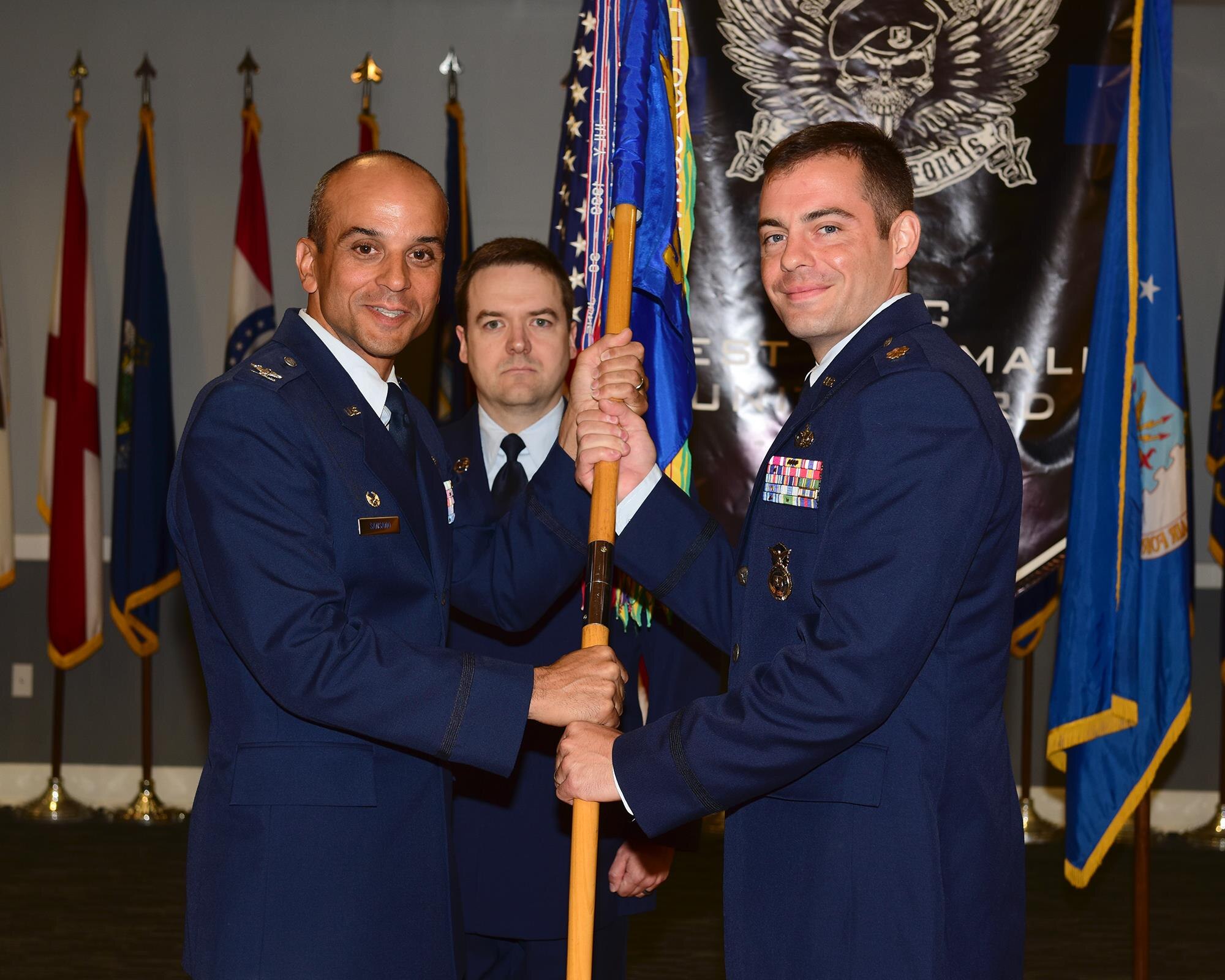 Col. Anthony Sansano, 14th Mission Support Group Commander, passes the 14th Security Forces Squadron guidon to Maj. Eric Eaton, the new 14th SFS Commander, July 13, 2017, at Columbus Air Force Base, Mississippi. Eaton was recently the Chief of Security for the 704th Munition Support Squadron at Ghedi Air Base, Italy. (U.S. Air Force photo by Elizabeth Owens)