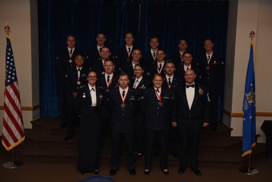 Col. Stacy Huser, 90th Missile Wing commander and Chief Master Sgt. Jeffery Steagall, 90th MW command chief, pose with the graduating Airman Leadership School Class 17-F students at F.E. Warren Air Force Base, Wyo., July 12, 2017. Enlisted Airmen must complete the rigorous professional military education course to become supervisors of other Airmen. (U.S. Air Force photo by Airman 1st Class Breanna Carter)
