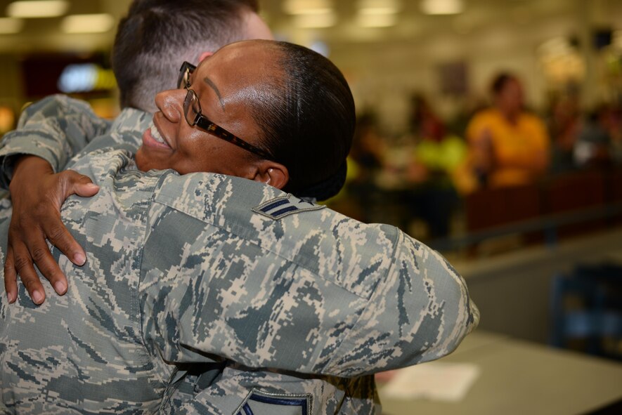 U.S. Air Force Airman 1st Class Brandon Beaudoin, 355th Medical Support Squadron personnel specialist, hugs Master Sgt. Khadijah Peterson-Carvalho, 355th Civil Engineer first sergeant, after receiving a gift card from her during the random acts of kindness event, at Davis-Monthan Air Force Base, Ariz., July 13, 2017. This was Peterson-Carvalho’s first time participating in the quarterly event that showcases one of the many ways first sergeants can play an active role in the lives of Airmen. (U.S. Air Force photo by Airman 1st Class Michael X. Beyer)