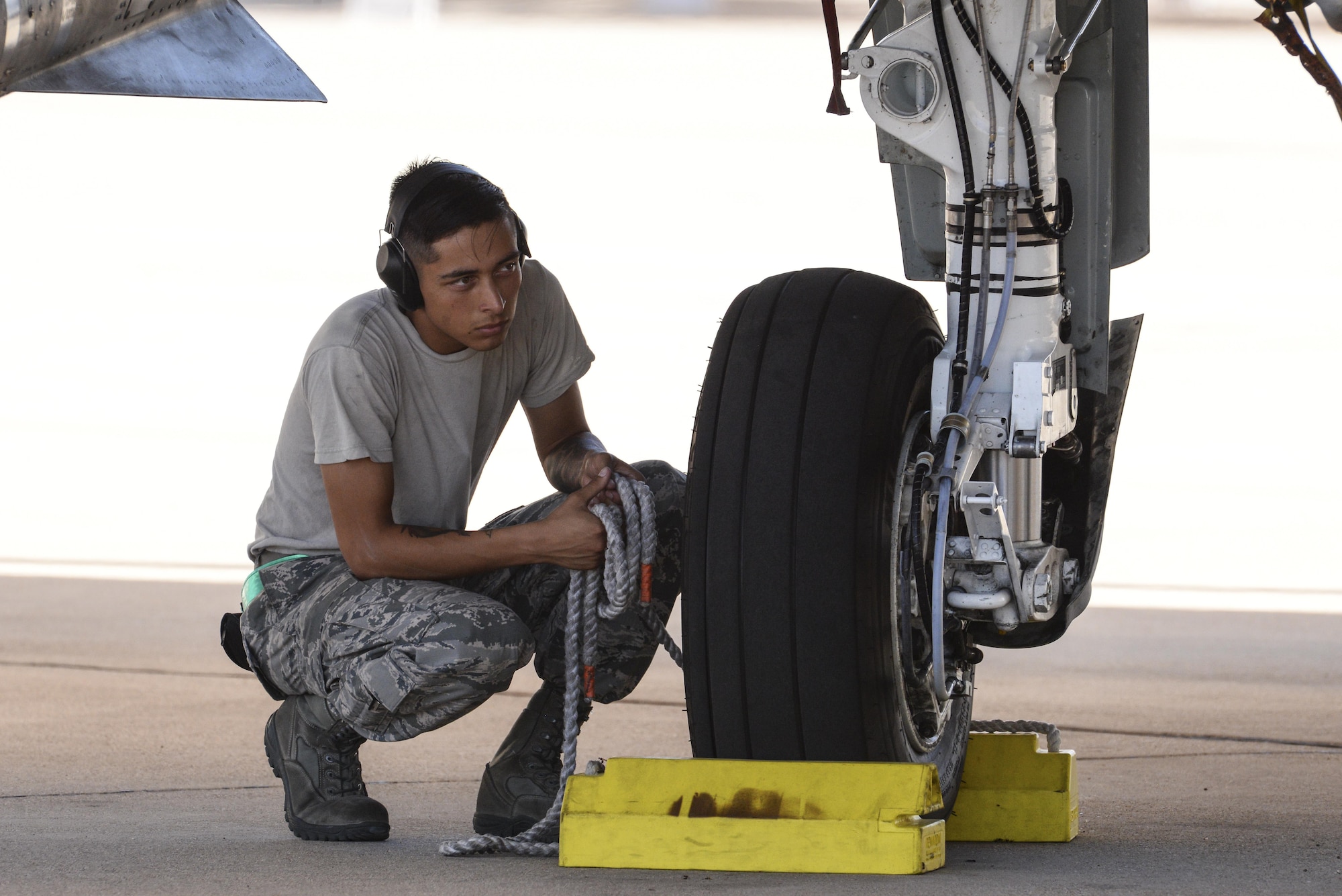 U.S. Air Force Senior Airman Julio España, 355th Aircraft Maintenance Squadron A-10C Thunderbolt II crew chief, waits to release pull chocks for an A-10 at Davis-Monthan Air Force Base, Ariz., July 14, 2017. The first production model of the A-10, the A-10A, was delivered to D-M AFB in Oct. 1975 and the A-10C arrived in Sept. 2007. (U.S. Air Force photo by Senior Airman Mya M. Crosby)