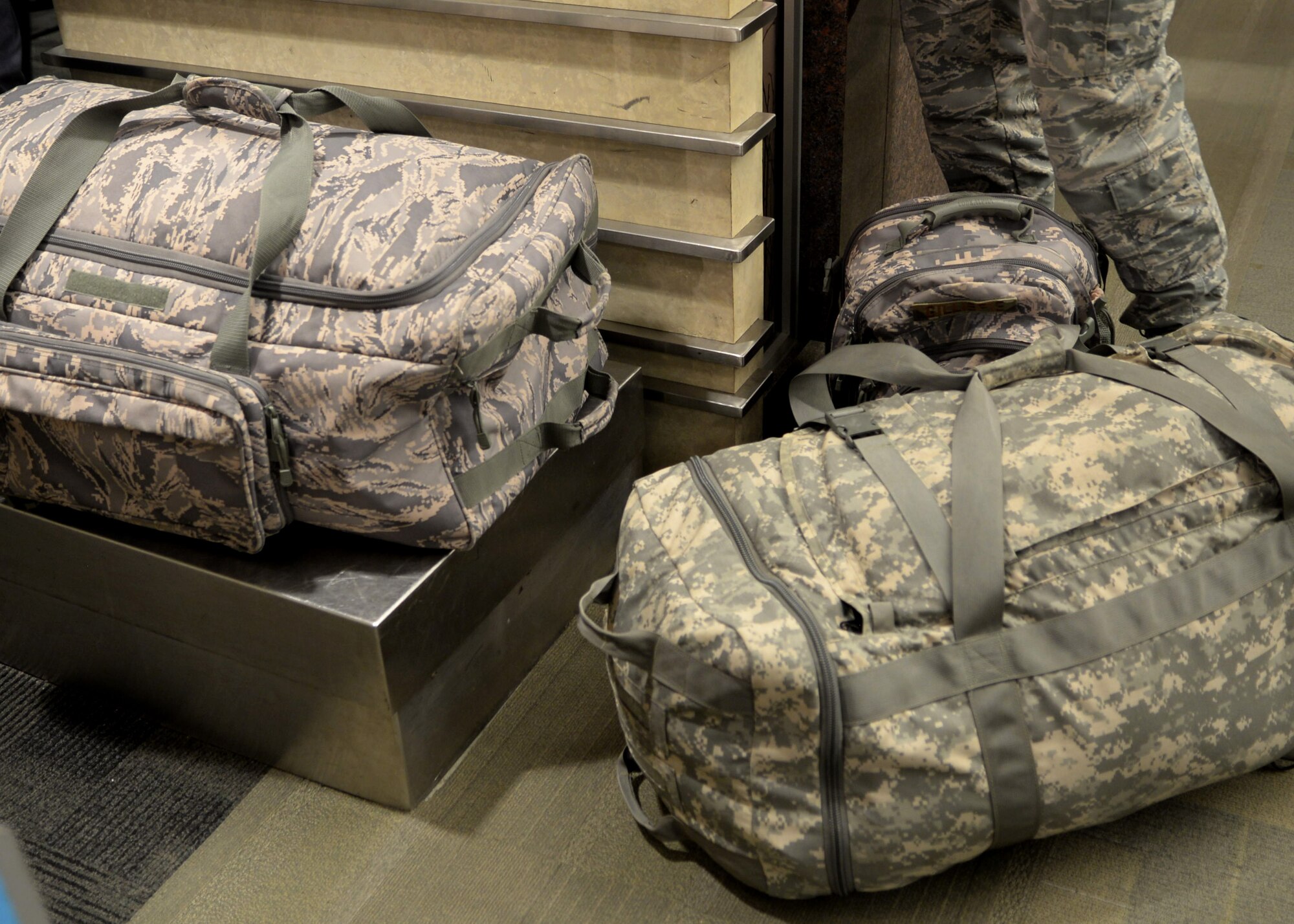 Senior Airman James Gillispie, an emergency management technician assigned to the 28th Civil Engineer Squadron, prepares to weigh his luggage before departing the Rapid City Regional Airport in Box Elder, S.D., June 12, 2017. Gillispie, along with other Airmen will be deploying to 10 different countries in the area of responsibility of U.S. Africa Command and U.S. Central Command throughout the summer, making this the largest deployment the squadron has been involved with in over 10 years. (U.S. Air Force photo by Senior Airman Denise M. Jenson)