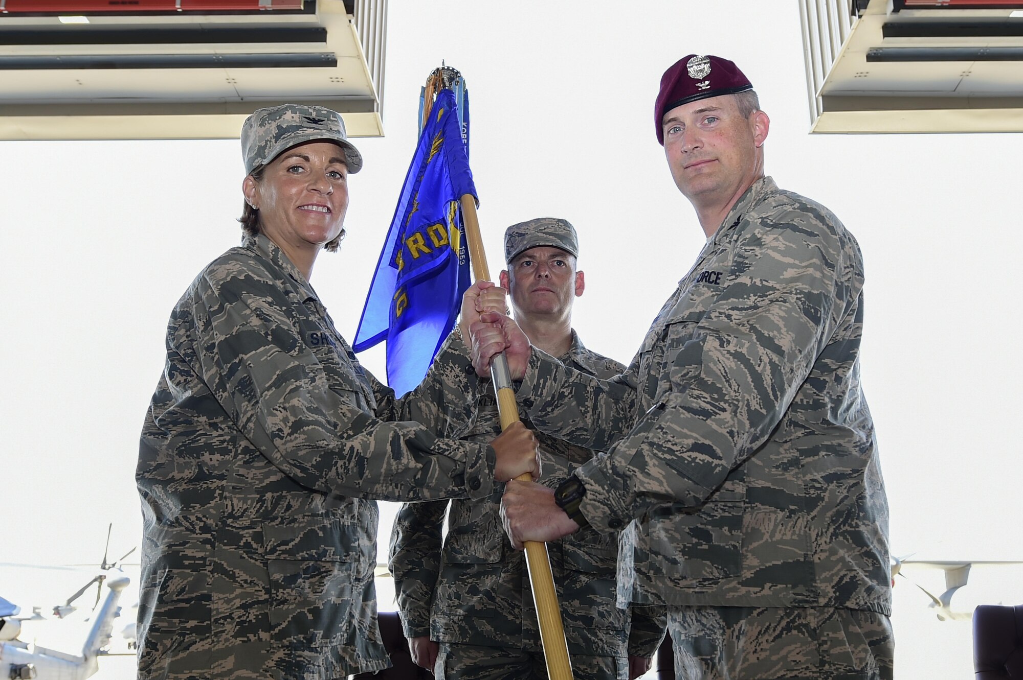 U.S. Air Force Col. Jennifer Short, 23d Wing commander, Moody Air Force Base, Ga., passes the guidon to Col. Jason Pifer, newly appointed 563rd Rescue Group commander, during a change of command ceremony at Davis-Monthan Air Force Base, Ariz., July 14, 2017. Pifer is a combat rescue officer and prior commander of the 48th Rescue Squadron at Davis-Monthan AFB. (U.S. Air Force photo by Staff Sgt. Chris Drzazgowski)