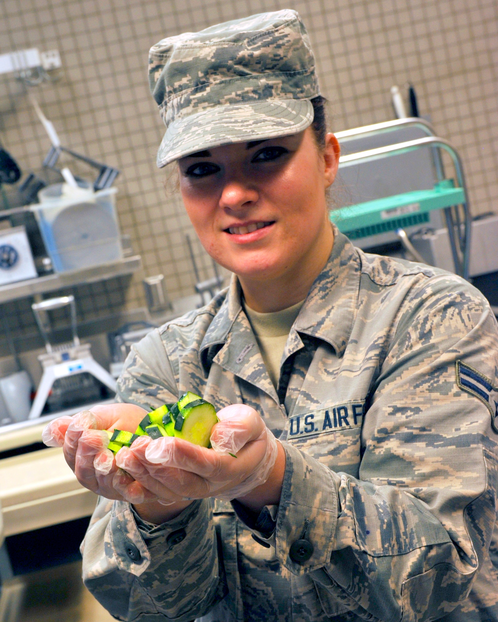 Airman 1st Class Jennifer Wascher, 56th FSS food service journeyman, takes a moment to showcase her cucumber cutting technique July 13, 2017 at Luke Air Force Base, Ariz. Wascher was one of the five Airman who attending a Chef Mentoring Program outside of Luke. (U.S. Air Force photo by Airman 1st Class Pedro Mota)