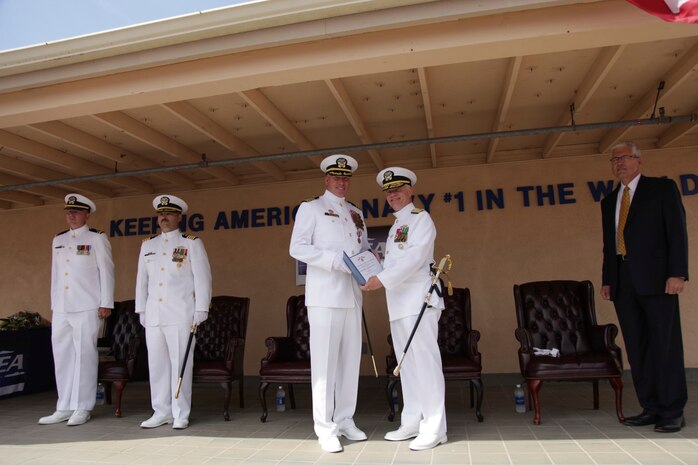 PORT HUENEME, Calif.—Naval Surface Warfare Center, Port Hueneme Division (NSWC PHD), held a change of command ceremony, July 10, where Capt. Stephen H. Murray relinquished command to Capt. Rafael “Ray” A. Acevedo. Pictured, from left to right, Lt. j.g. Victor B. Stevens, deputy chaplain, Naval Base Ventura County, Capt. Rafael “Ray” A. Acevedo, Capt. Stephen H. Murray, being presented with a Meritorious Service Medal and citation by Rear Adm. John W. Ailes, deputy commander, Fleet Readiness Directorate, Space and Naval Warfare Systems Command, and Dr. William H. Luebke, technical director, NSWC PHD. 