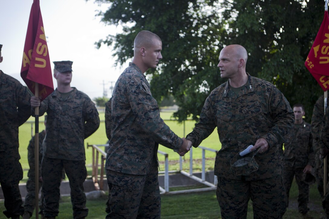 U.S. Marine Maj. Gen. David G. Bellon, the commander of U.S. Marine Corps Forces, South, recognizes U.S. Marine Sgt. Jordan D. Finch, the flight line staff noncommissioned officer in charge with the Air Combat Element, Special Purpose Marine Air-Ground Task Force - Southern Command, for his outstanding work ethic at Soto Cano Air Base, Honduras, June 29, 2017. The Marines and sailors of SPMAGTF-SC are deployed to Central America from June to November 2017 to conduct security cooperation training and engineering projects with their counterparts in Honduras, Guatemala, Belize and El Salvador.  (U.S. Marine Corps photo by Cpl. Melanie Kilcline)