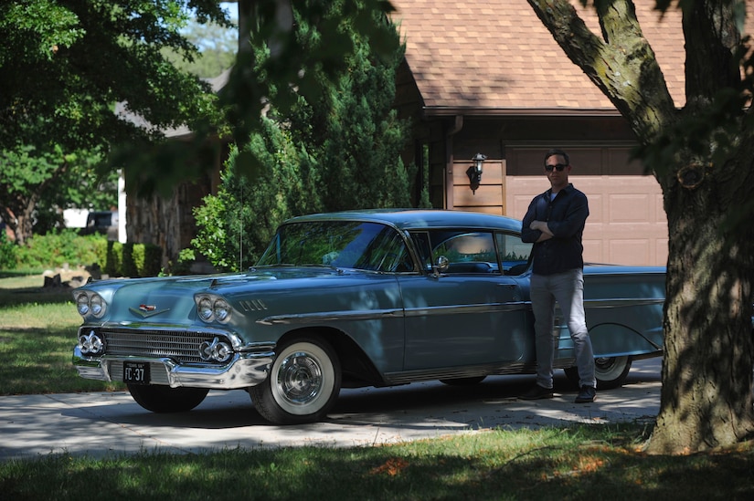 Master Sgt. Bobby McCrary, 22nd Force Support Squadron NCO in-charge of Honor Guard, poses for a photo in his car, July 13, 2017, at his home in Derby, Kan. McCrary built this car with his grandfather, a 1958 Chevy Impala. (U.S. Air Force photo/Senior Airman Jenna K. Caldwell)