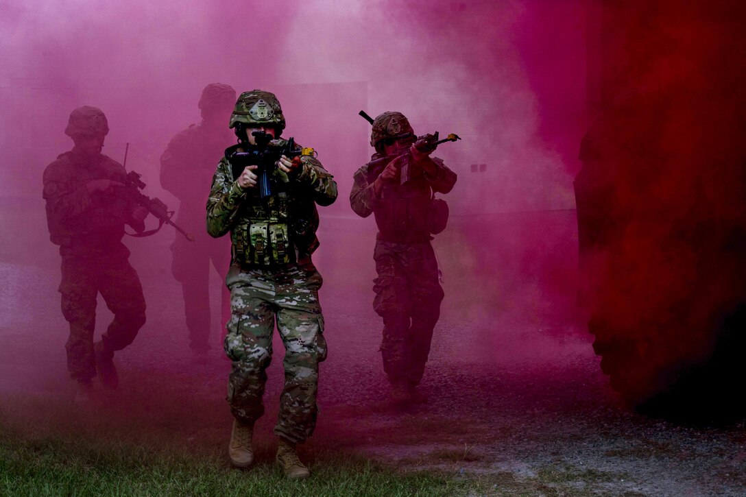 Airmen move through smoke used for cover during a combat simulation at Moody Air Force Base, Ga., July 11, 2017. The airmen are assigned to the 823rd Base Defense Squadron, which was giving a demonstration of its capabilities to Chief Master Sgt. David Wade, the 9th Air Force command chief. Air Force photo by Staff Sgt. Eric Summers Jr.