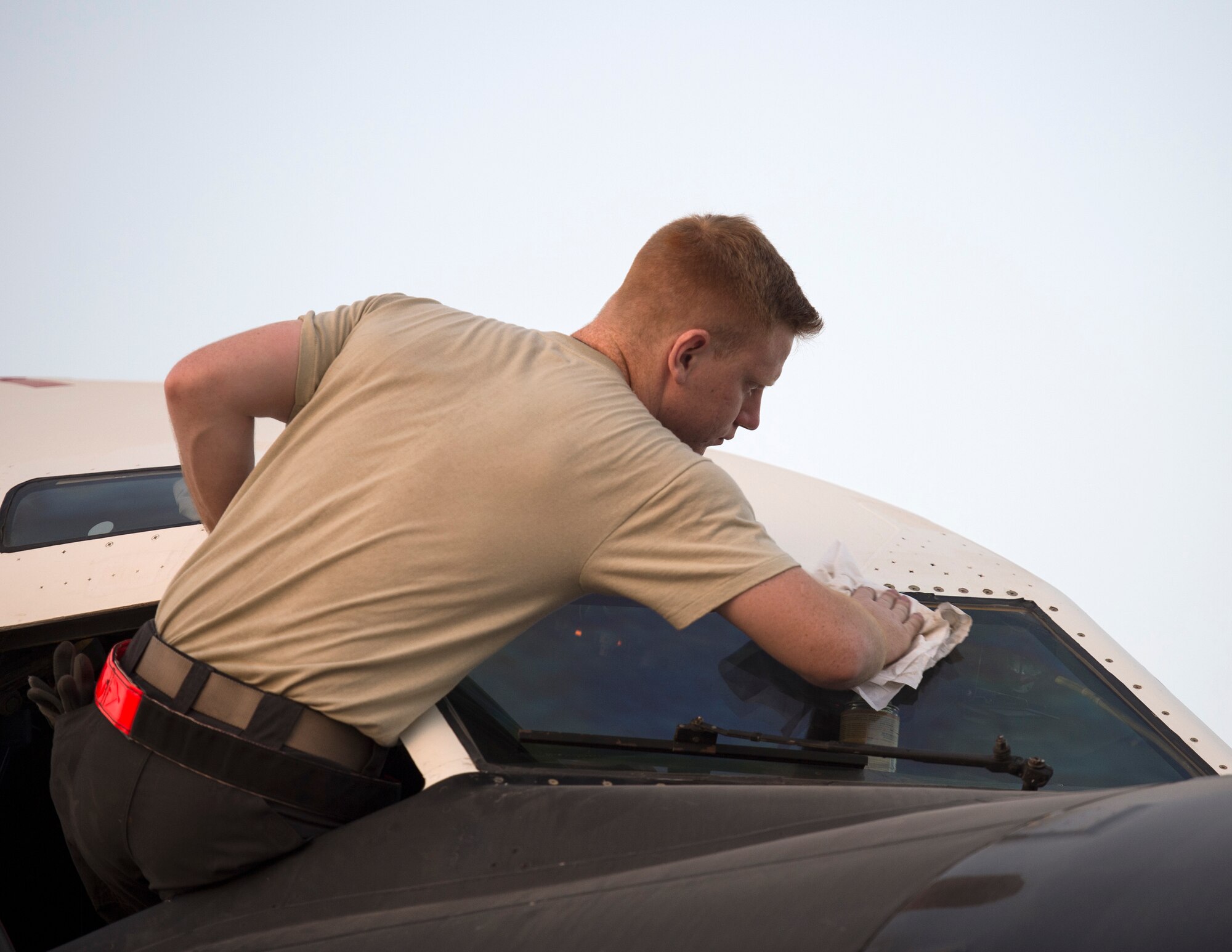 U.S Air Force Airman 1st Class Jacob Schwartz, a crew chief with the 763rd Expeditionary Aircraft Maintenance Unit, cleans the windows on RC-135V/W Rivet Joint at Al Udeid Air Base, Qatar, July 4, 2017. Schwartz is responsible for keeping the RC-135V/W Rivet Joint operational so it can provide near real time on-scene intelligence collection and analysis throughout the U.S. Air Forces Central Command area of responsibility. (U.S. Air Force photo by Tech. Sgt. Amy M. Lovgren)