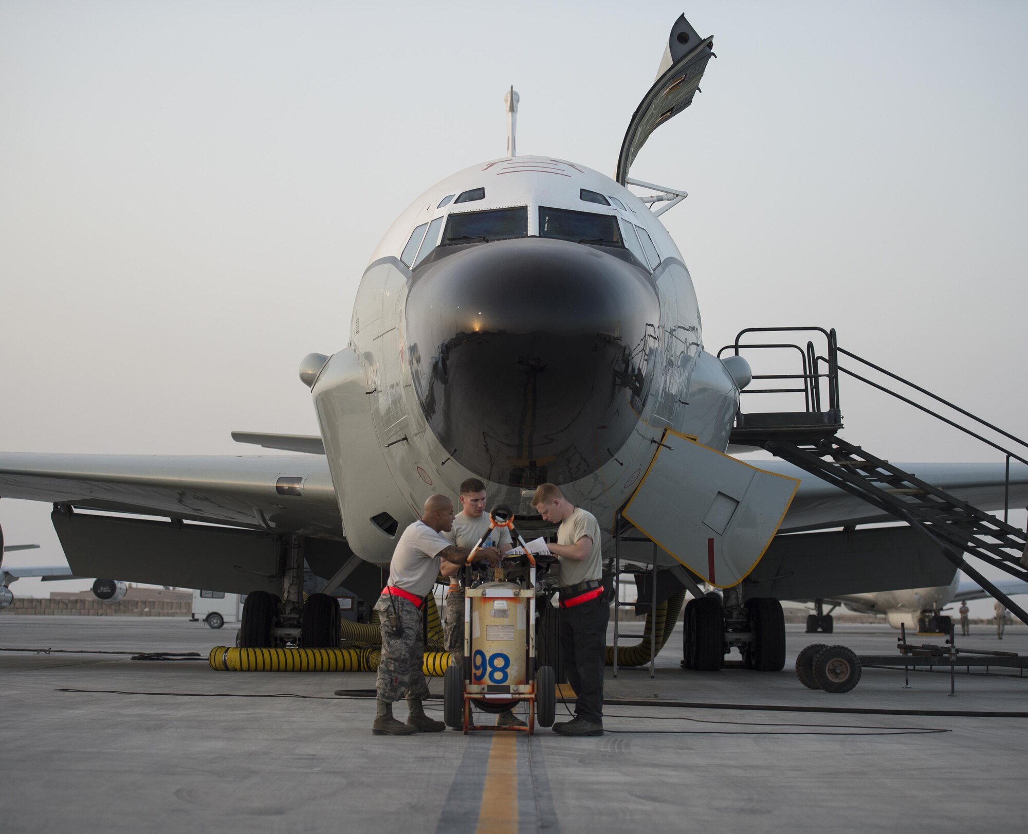 U.S Air Force Airmen with the 763rd Expeditionary Aircraft Maintenance Unit, review a RC-135V/W Rivet Joint paper work at Al Udeid Air Base, Qatar, July 4, 2017.  The Airmen are responsible for keeping the RC-135V/W Rivet Joint operational so it can provide near real time on-scene intelligence collection and analysis throughout the U.S. Air Forces Central Command area of responsibility. (U.S. Air Force photo by Tech. Sgt. Amy M. Lovgren)