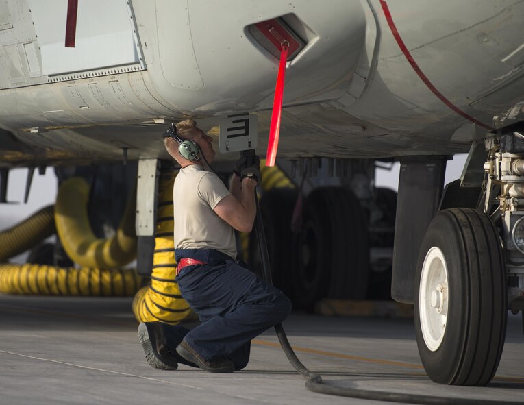 U.S Air Force Staff Sgt. Bruce Boland, a hydraulic technician with the 763rd Expeditionary Aircraft Maintenance Unit, plugs in an external power supply to a RC-135V/W Rivet Joint at Al Udeid Air Base, Qatar, July 4, 2017. Boland is responsible for keeping the RC-135V/W Rivet Joint operational so it can provide near real time on-scene intelligence collection and analysis throughout the U.S. Air Forces Central Command area of responsibility. (U.S. Air Force photo by Tech. Sgt. Amy M. Lovgren)