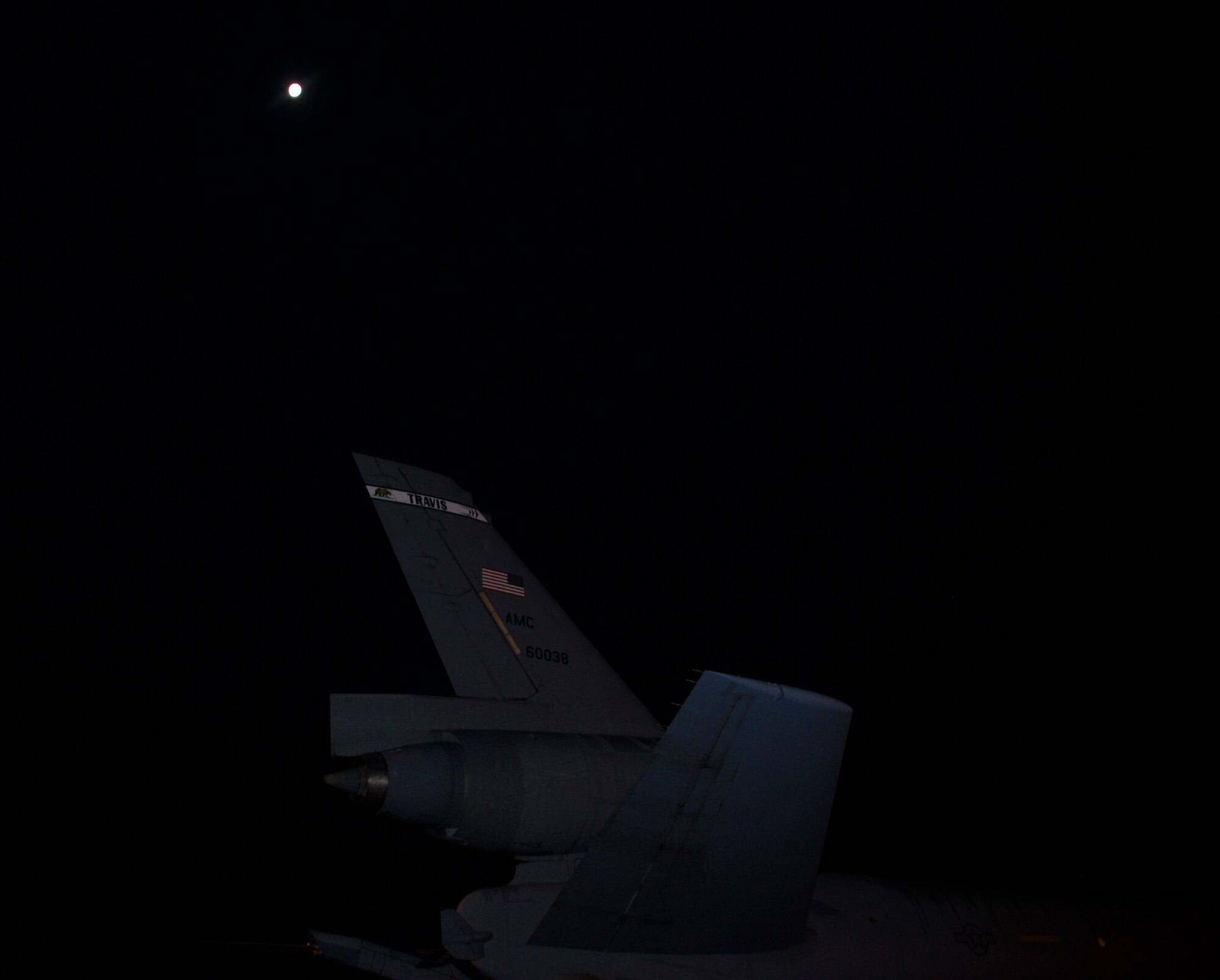 A KC-10 Extender sits ready on the runway under a full moon July 11, 2017 at Joint Base Pearl Harbor-Hickam, Hawaii. A combined crew from the 6th and 9th ARS at Travis Air Force Base supported Exercise Talisman Saber 2017 by executing Exercise Ultimate Reach, a strategic refueling and airdrop mission in which three KC-10s refueled five C-17 Globemaster IIIs carrying U.S. Army, Australian and Canadian paratroopers prior to an airdrop. TS 17 is a biennial exercise in Australia that focuses on bilateral military training between U.S. Pacific Command forces and the Australian Defence Force to improve U.S.-Australia combat readiness, increase interoperability, maximize combined training opportunities and conduct maritime prepositioning and logistics operations in the Pacific. (U.S. Air Force photo by 2nd Lt. Sarah Johnson)
