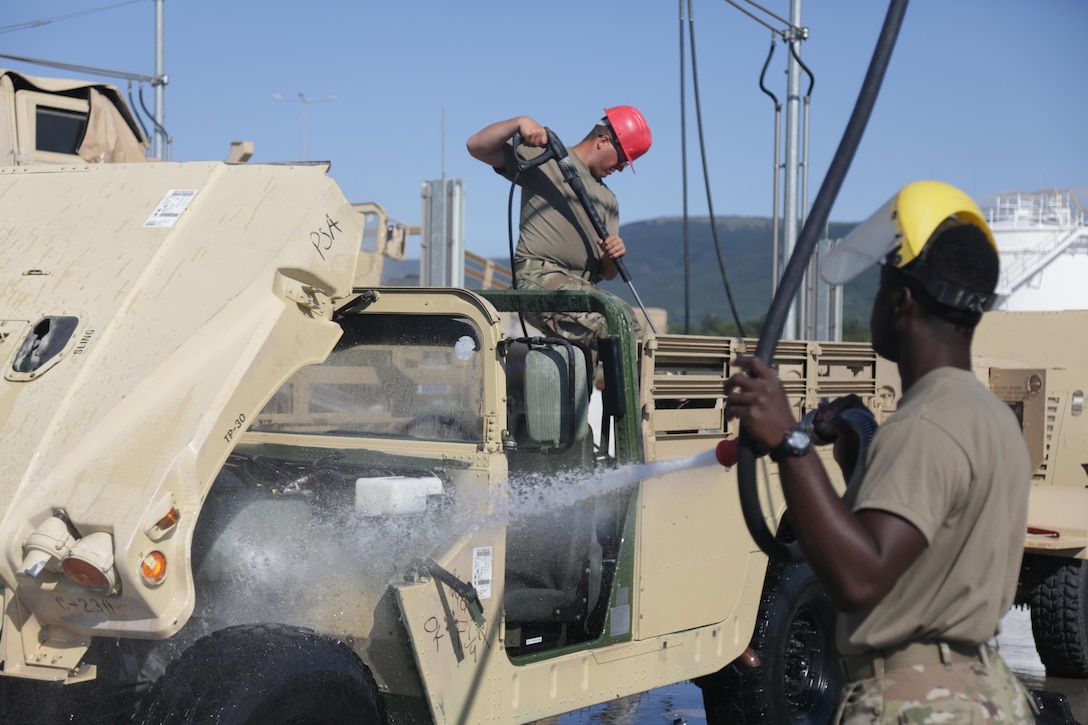 Soldiers from the 86th Expeditionary Signal Battalion wash trucks and equipment, July 14, at the wash rack on Novo Selo Training Area in Bulgaria. Logistical support for the wash facility is maintained by the Black Sea Area Support Team. The BSAST oversees and executes all aspects of operational and strategic operations for NSTA and the Mihail Kolgalniceanu Airbase in Romania.