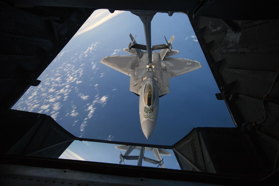A U.S. Air Force F-22 Raptor assigned to Joint Base Langley-Eustis, Va., is refueled by a KC-10 Extender crewed by members of the 78th Air Refueling Squadron, 514th Air Mobility Wing, flies over the Atlantic Ocean July 15, 2017. The F-22 is assigned to Joint Base Langley-Eustis, Va., and is the Air Force’s 5th generation fighter aircraft. The KC-10 is an Air Mobility Command advanced tanker and cargo aircraft designed to provide increased global mobility for U.S. Armed Forces and is assigned to the 305th Air Mobility Wing and is maintained and flown by the 514th Air Mobility Wing, Air Force Reserve Command and the 305th. Both units are located at Joint Base McGuire-Dix-Lakehurst, N.J. (U.S. Air Force photo by Master Sgt. Mark C. Olsen/Released)
