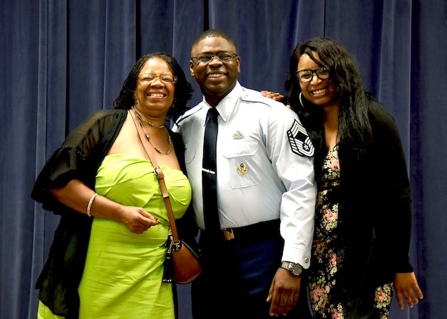 NEW CASTLE AIR NATIONAL BASE, Del.- Delaware Air National Guard’s newest Chief Master Sergeant, Chief Robbie Hunt takes a photo with his mother, Karen Hunt-Sims, and his sister, Corea Nimmons, right, and after his is tacked on with E-9 Chevrons during a promotion ceremony held in his honor on July 15, 2017.  (U.S. Air National Guard photo by TSgt Gwendolyn Blakley/Released).