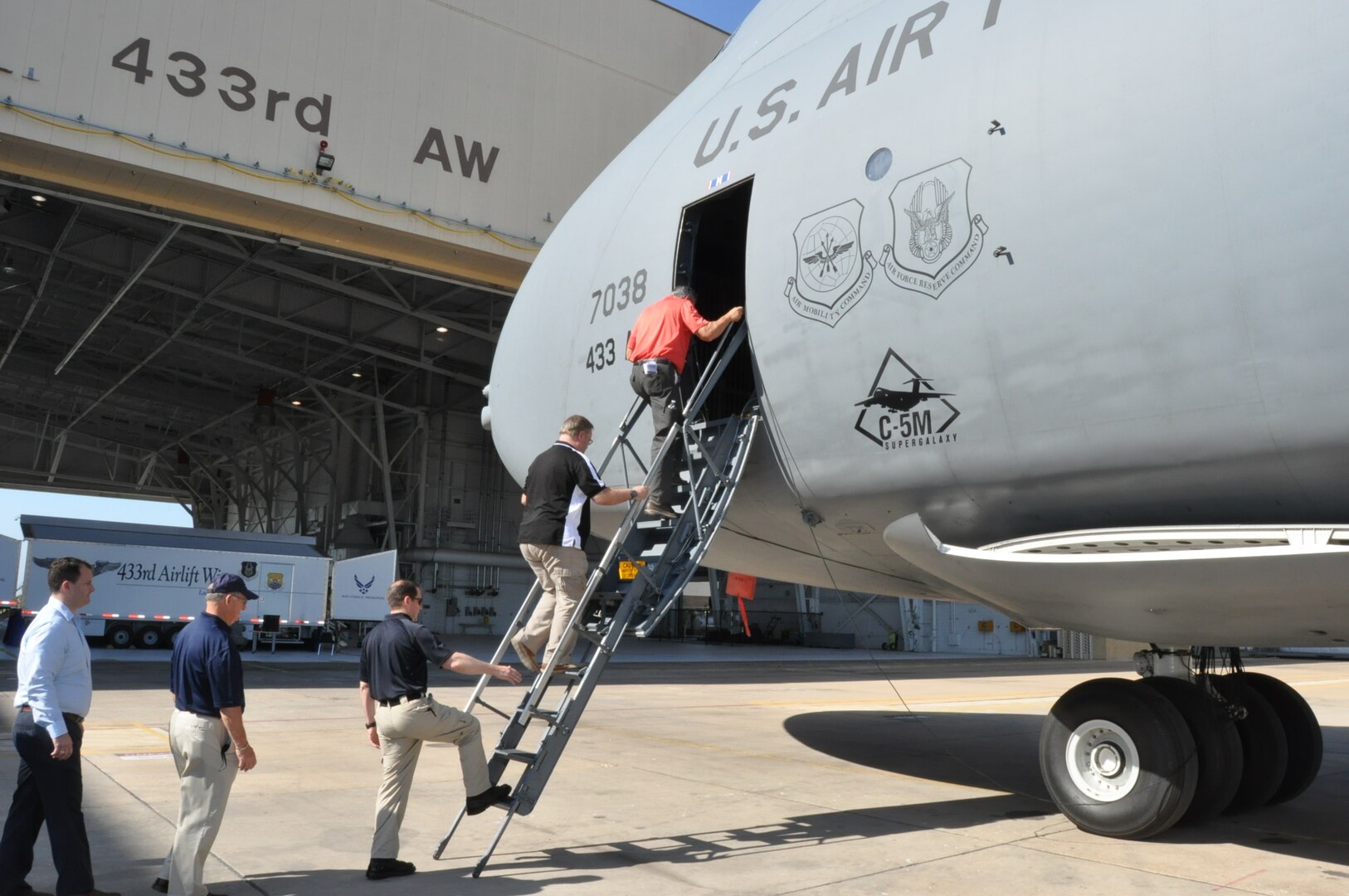 A group of 10 433rd Airlift Wing honorary commanders make their way up the stairs into the C-5M Super Galaxy during the 433rd Maintenance Group Honorary Commander’s Tour July 15, 2017.  The tour allows the community leaders to see the aircraft up close and learn about the maintainer’s responsibilities associated with the largest aircraft in the U.S. Air Force’s fleet.  (U.S. Air Force photo/Senior Airman Bryan Swink)