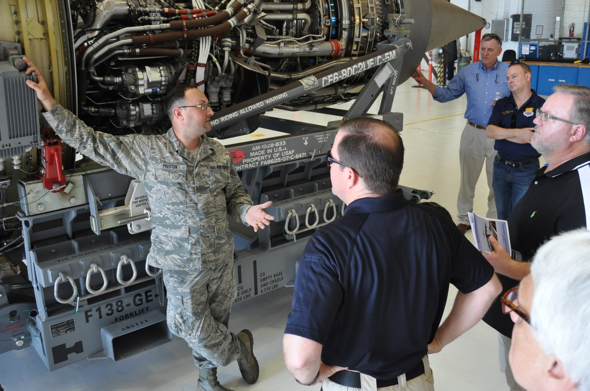 Tech Sgt. Sean Preston, 433rd Maintenance Squadron aerospace propulsion technician, showcases the General Electric engines for the C-5M Super Galaxy during the 433rd Maintenance Group Honorary Commander’s Tour July 15, 2017.  The tour is designed to inform the honorary commanders of the roles and responsibilities the Airmen of the 433rd MXG provide to the success of the Alamo Wing’s mission.  (U.S. Air Force photo/Senior Airman Bryan Swink)