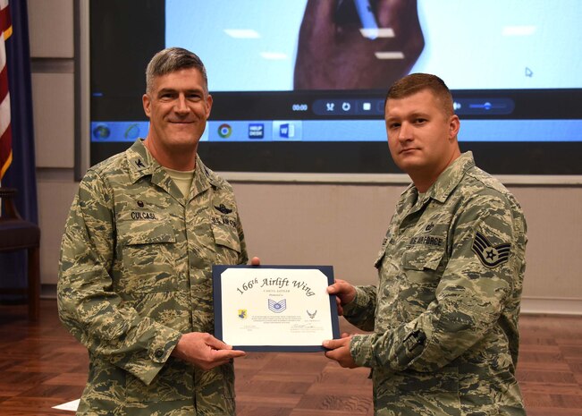 NEW CASTLE AIR NATIONAL GUARD BASE, Del.- Staff Sgt. Casey Sattler is presented with a certificate for promotion to Technical Sergeant by Col. Robert Culcasi, commander, 166th Airlift Wing on July 15, 2017. (U.S. Air National Guard photo by Tech. Sgt. Gwendolyn Blakley) 