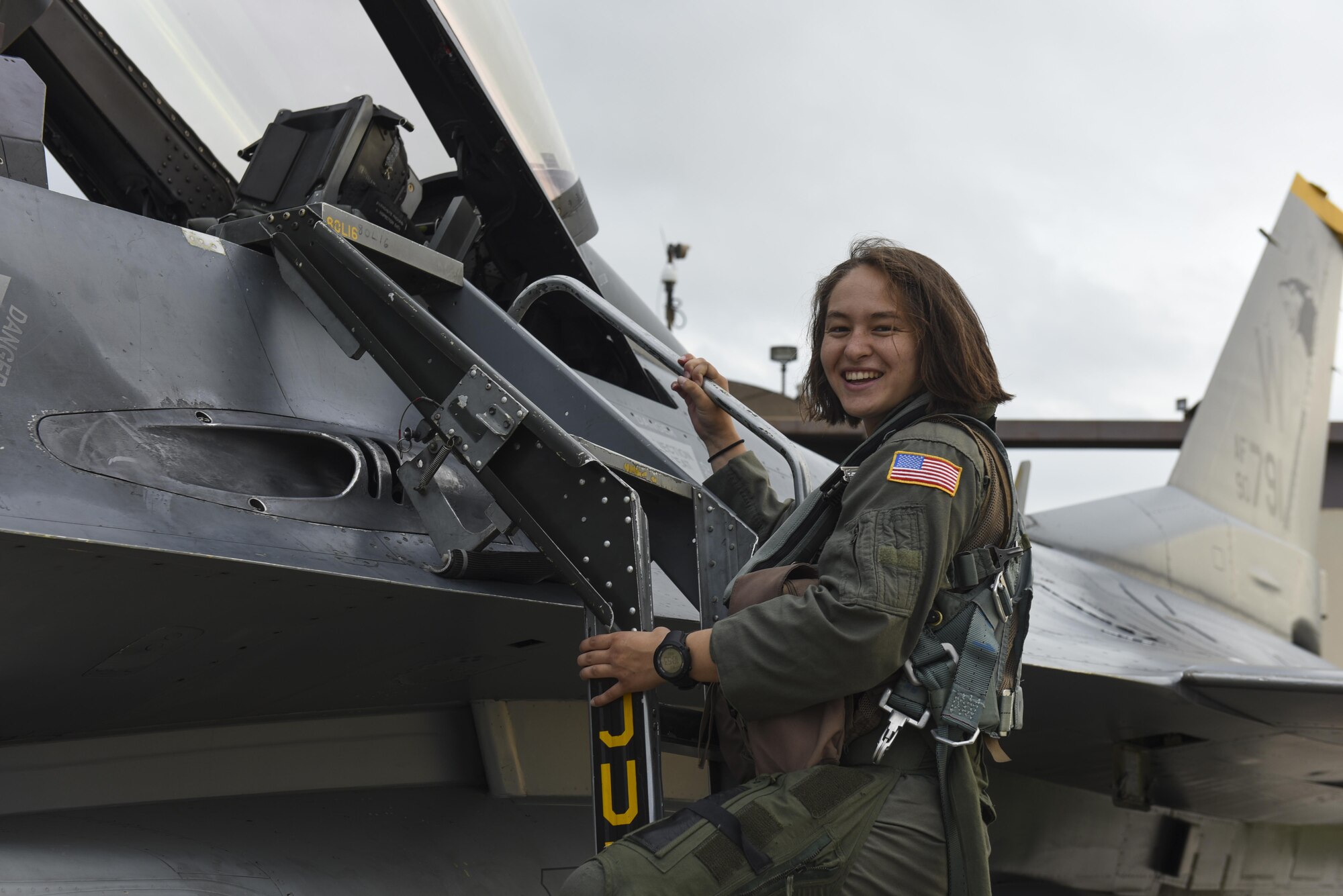 U.S. Air Force Academy Cadet 2nd Class Madison Tung climbs out of an F-16 Fighting Falcon at Kunsan Air Base, Republic of Korea, July 11, 2017. While visiting various bases through the Operation Air Force program, juniors from the Air Force Academy learn about different career fields by shadowing officer and enlisted Airmen and learn what specific operational base missions look like. (U.S. Air Force photo by Senior Airman Michael Hunsaker/Released)