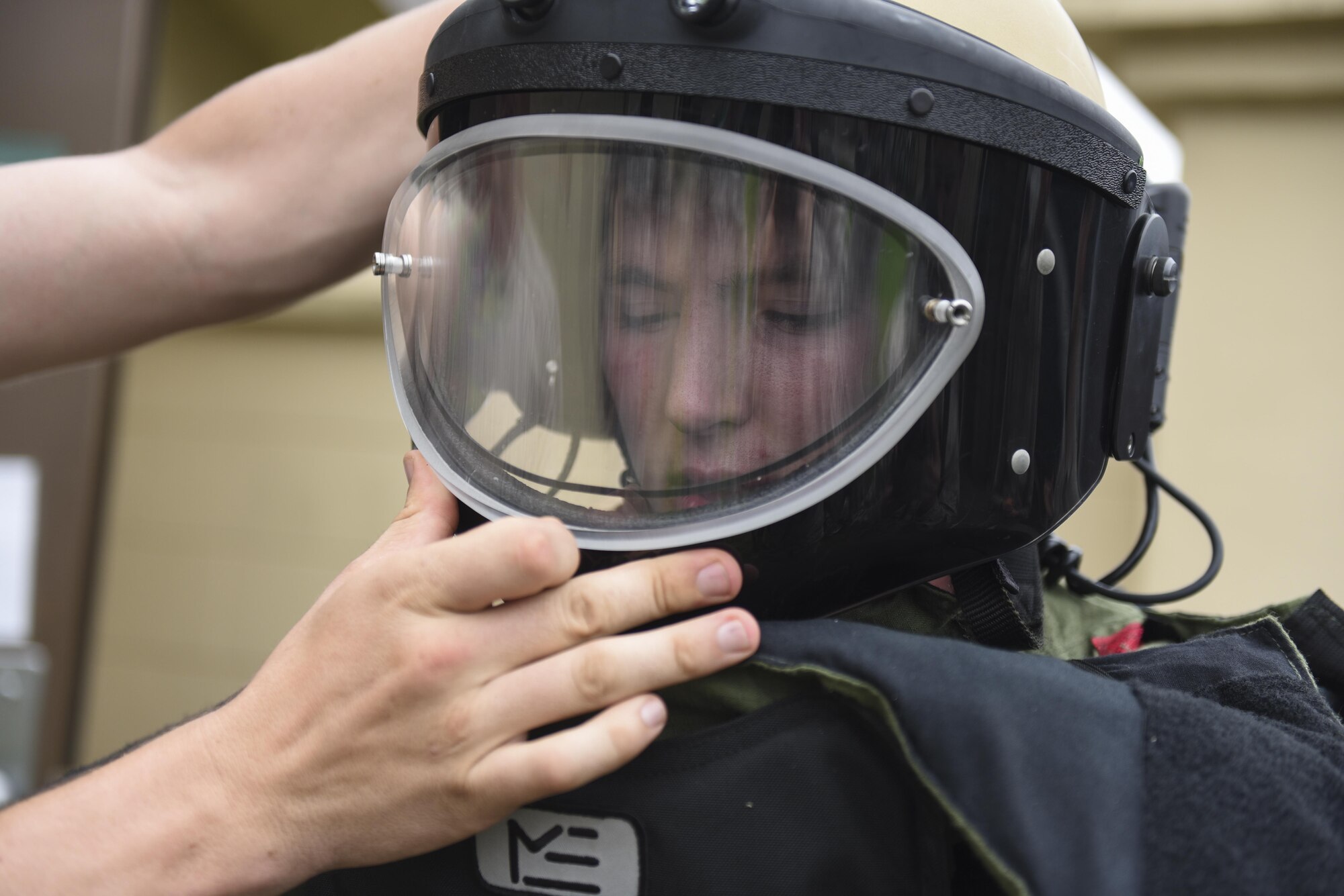 U.S. Air Force Academy Cadet 2nd Class Ryan Ramseyer tries on an explosive ordnance disposal suit at Kunsan Air Base, Republic of Korea, July 11, 2017. The visit allows cadets to travel different bases to learn about different careers and missions on the officer and enlisted tier and is a part of the Air Force Academy’s Operation Air Force program. (U.S. Air Force photo by Senior Airman Michael Hunsaker/Released)