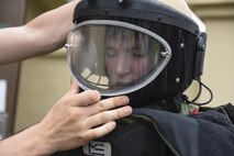 U.S. Air Force Academy Cadet 2nd Class Ryan Ramseyer tries on an explosive ordnance disposal suit at Kunsan Air Base, Republic of Korea, July 11, 2017. The visit allows cadets to travel different bases to learn about different careers and missions on the officer and enlisted tier and is a part of the Air Force Academy’s Operation Air Force program. (U.S. Air Force photo by Senior Airman Michael Hunsaker/Released)