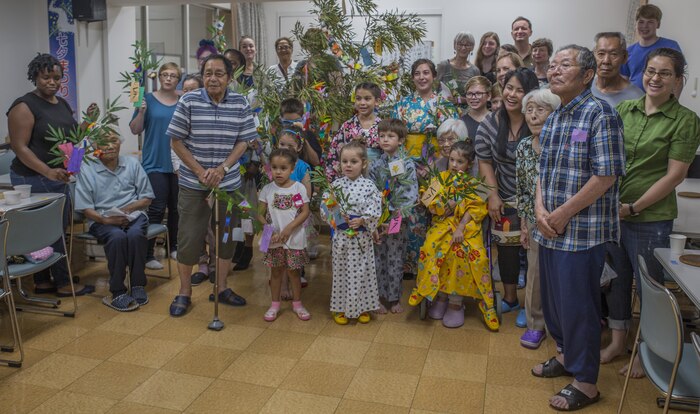 Marine Corps Air Station Iwakuni residents pose for a group photo with Japanese locals during a visit to Kinjuen Nursing Home with the MCAS Iwakuni Cultural Adaptation Program at Iwakuni City, Japan, July 7, 2017. The nursing home invited Americans from the air station to celebrate Tanabata, also known as the star festival. Participants in the event enjoyed traditional foods and other activities, like somen nagashi, or sliding somen noodles, and tying their wish to a bamboo branch. (U.S. Marine Corps photo by Lance Cpl. Gabriela Garcia-Herrera)