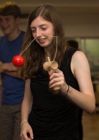 Hannah Walker, a native of Michigan and Marine Corps Air Station Iwakuni visitor, plays with a kendama toy during a visit to Kinjuen Nursing Home in Iwakuni City, Japan, July 7, 2017. The invitation to the nursing home was set up through the MCAS Iwakuni Cultural Adaptation Program to celebrate Tanabata, also known as the star festival. It gave tenants of the air station a taste of Japanese culture and friendship. (U.S. Marine Corps photo by Lance Cpl. Gabriela Garcia-Herrera)