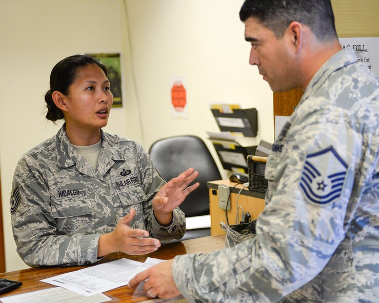 U.S. Air Force Technical Sgt. Ma Riolette Hidalgo, military pay technician assigned to the 379th Expeditionary Comptroller Squadron, Financial Services Flight, assists a customer at Al Udeid, Air Base, Qatar, May 24, 2017. The FMF assists deployed military members with travel pay, military pay and dispersal of funds. (U.S. Air National Guard photo by Tech. Sgt. Bradly A. Schneider/Released)