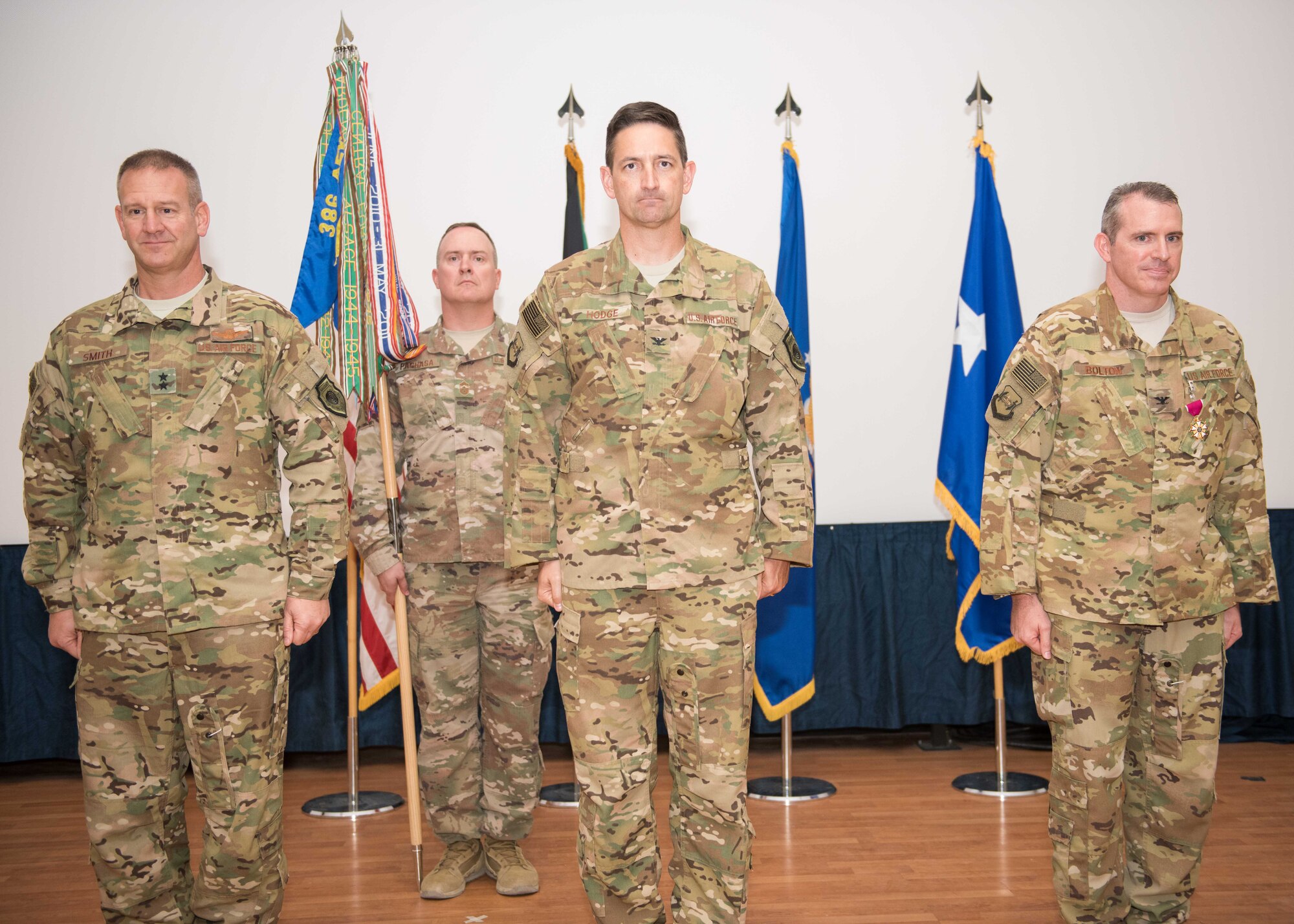 From left to right, Maj. Gen. Dirk D. Smith, the deputy commander, Combined Joint Task Force-Operation Inherent Resolve, U.S. Central Command and the commander, 9th Air Expeditionary Task Force-Levant, U.S. Air Forces Central Command, Col. Stephen L. Hodge, the 386th Air Expeditionary Wing commander and Col. Charles D. Bolton, the 386th AEW outgoing commander, stand at attention in front the 386th AEW Airmen and mission partners during a change of command ceremony at an undisclosed location in Southwest Asia, July 12, 2017. (U.S. Air Force photo by Tech. Sgt. Jonathan Hehnly)